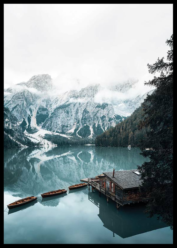 Photograph of snow-capped mountains, wooden pier and rowboats on a mirror-like lake-12