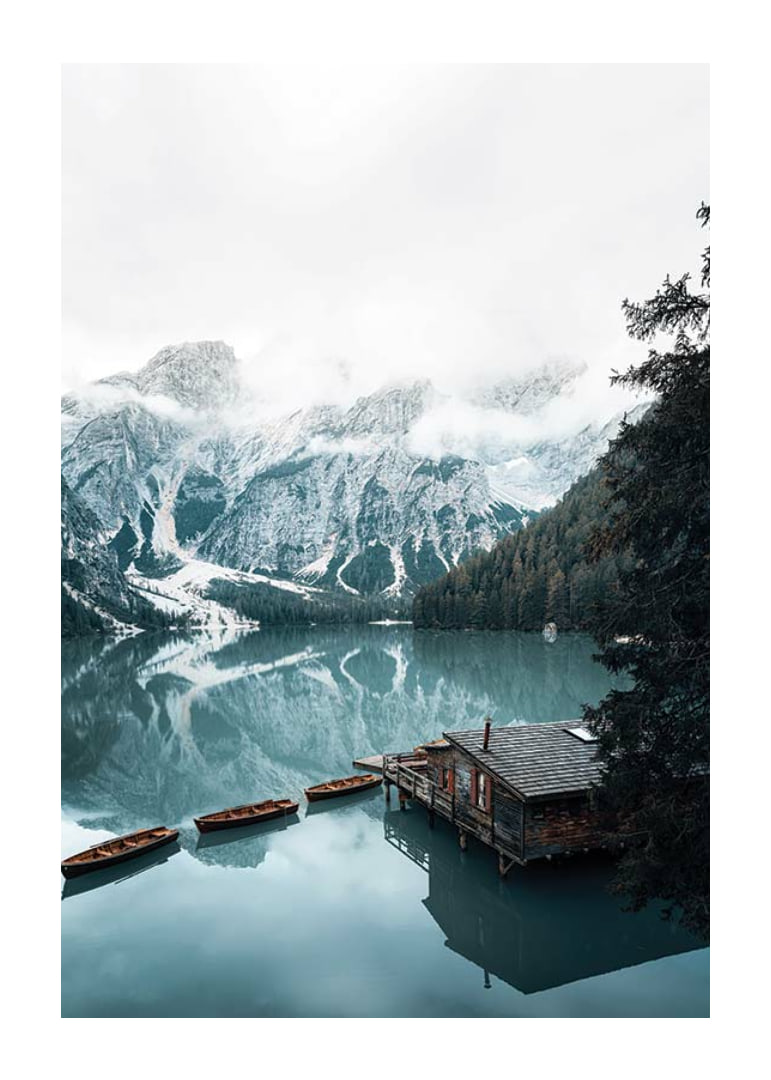 Photograph of snow-capped mountains, wooden pier and rowboats on a mirror-like lake-12