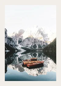 Photograph of rowboats on mirror-like lake, snow-capped mountains-3