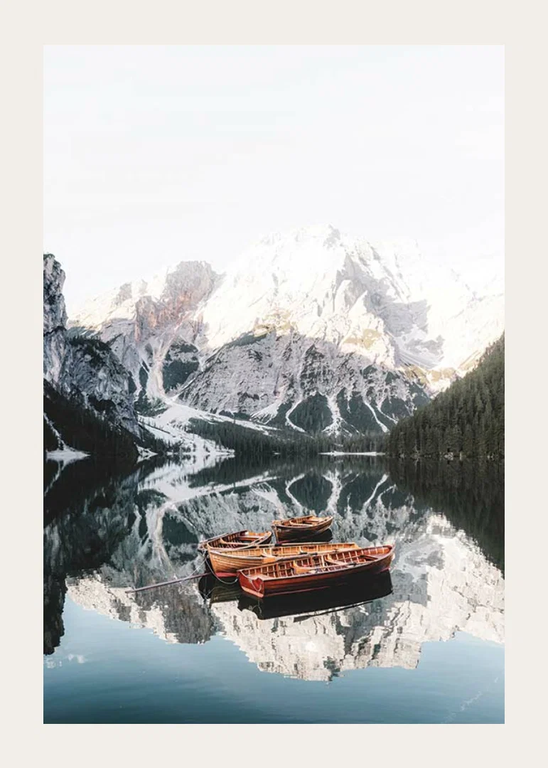 Photograph of rowboats on mirror-like lake, snow-capped mountains-12