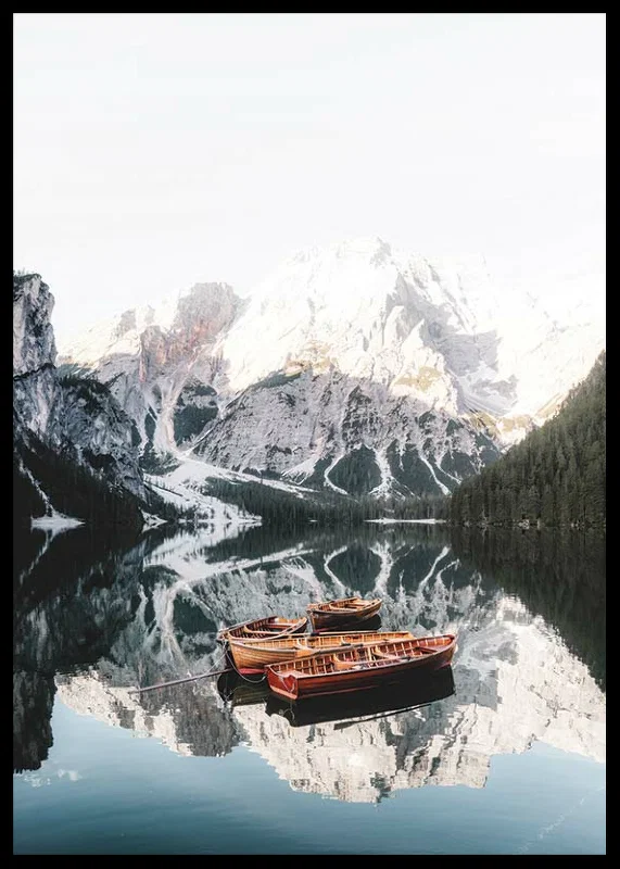 Photograph of rowboats on mirror-like lake, snow-capped mountains-12