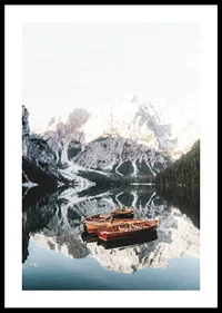 Photograph of rowboats on mirror-like lake, snow-capped mountains-0