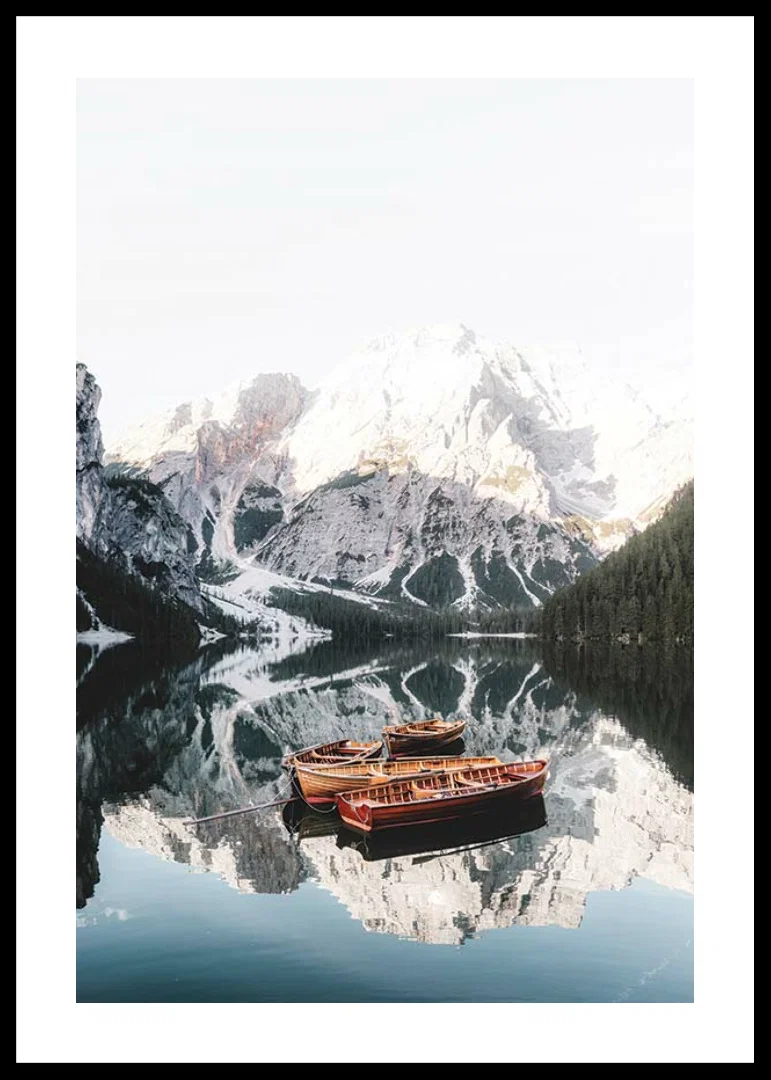 Photograph of rowboats on mirror-like lake, snow-capped mountains-12