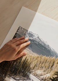 Photograph of cascading waterfall with pine forest and snow-capped mountains-9