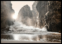 Photograph of waves crashing against rocks in soft backlight-6