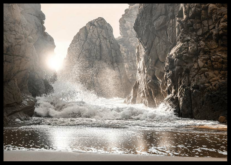 Photograph of waves crashing against rocks in soft backlight-12