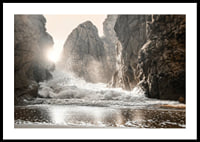 Photograph of waves crashing against rocks in soft backlight-0