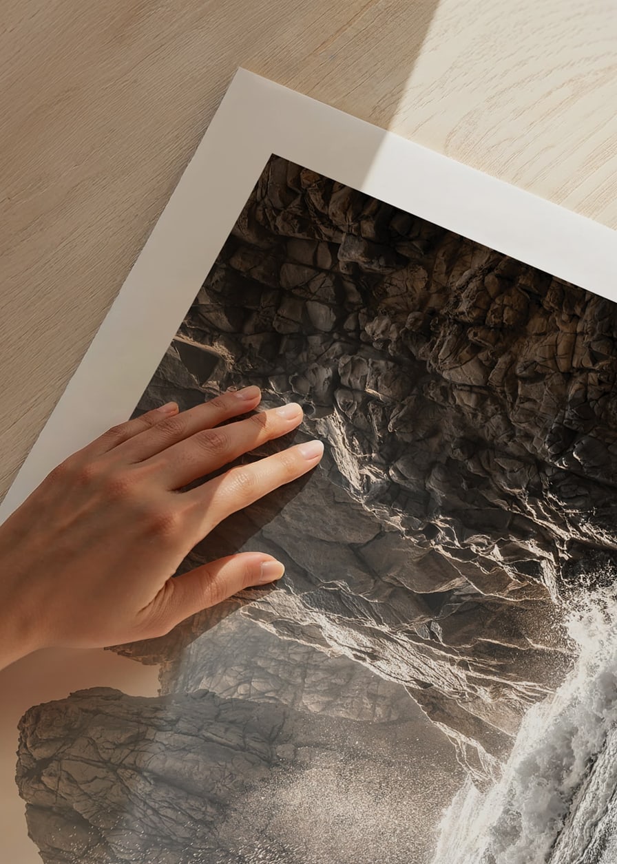 Photograph of waves crashing against rocks in soft backlight-12