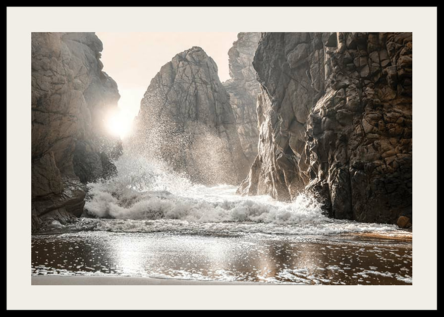 Photograph of waves crashing against rocks in soft backlight-12