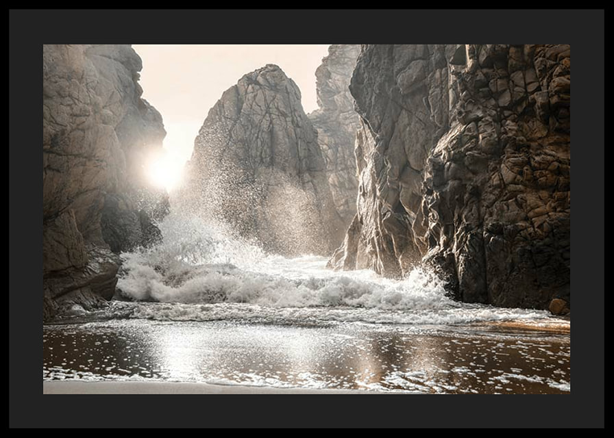 Photograph of waves crashing against rocks in soft backlight-12