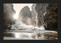 Photograph of waves crashing against rocks in soft backlight-5