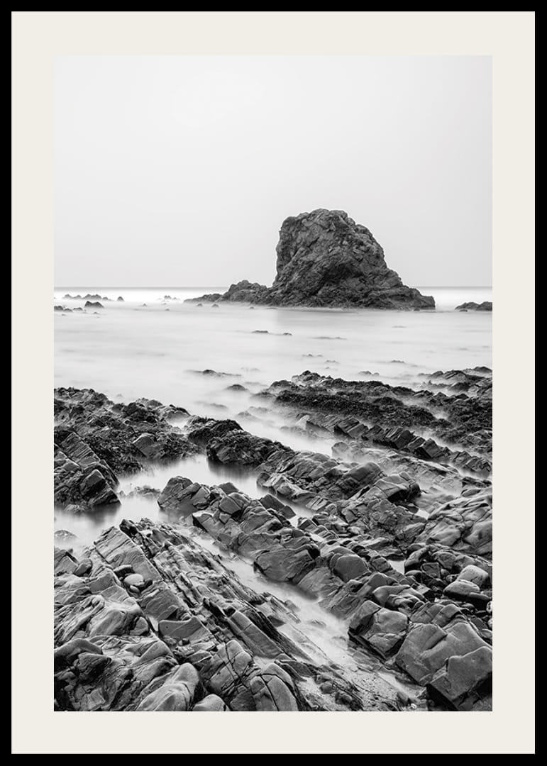 Black and white photography of dramatic sea cliffs and calm water-12