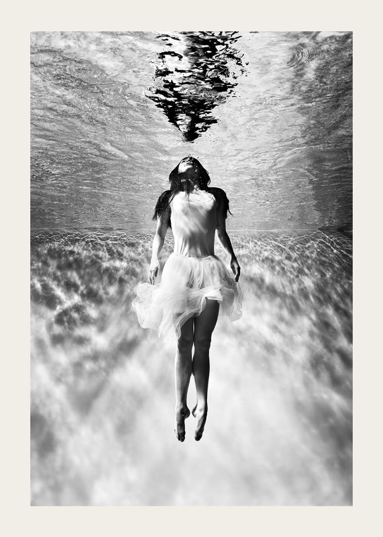 Black and white photo art of woman in dress under water surface-12