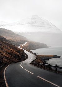 Photographic landscape with winding road, sea and snow-capped mountains-7