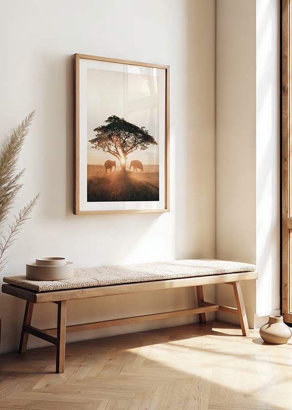 Photograph of two elephants by large tree at sunrise-12