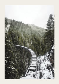 Fénykép egy hófödte vasúti hídról lucfenyőerdő felett téli tájban-3