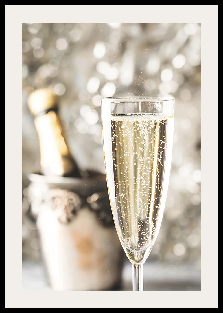 Photographic close-up of champagne glass with bubbles and blurred bottle in the background-12