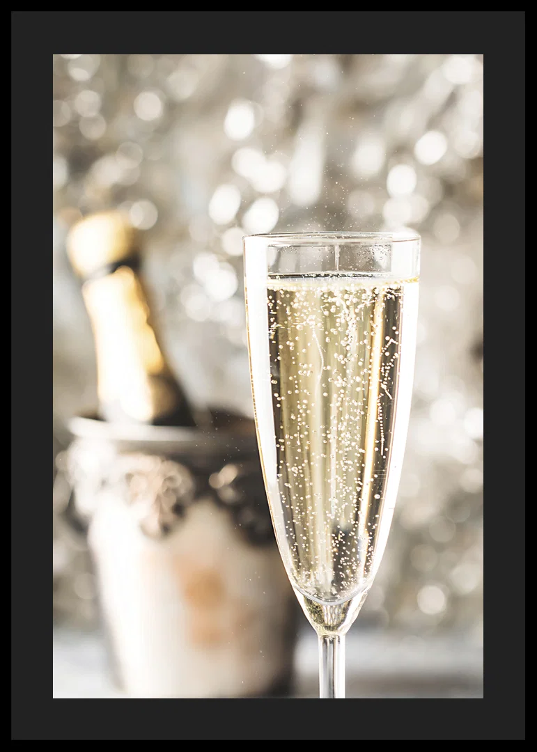 Photographic close-up of champagne glass with bubbles and blurred bottle in the background-12