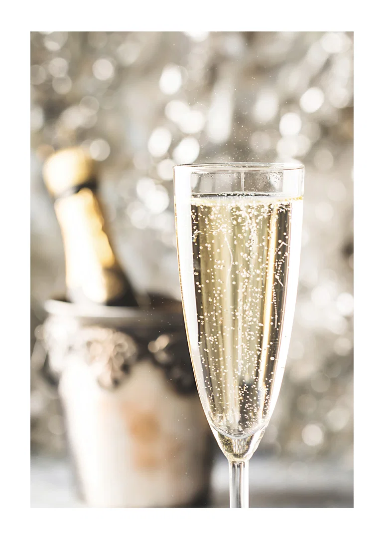 Photographic close-up of champagne glass with bubbles and blurred bottle in the background-12