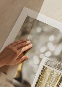 Photographic close-up of champagne glass with bubbles and blurred bottle in the background-9
