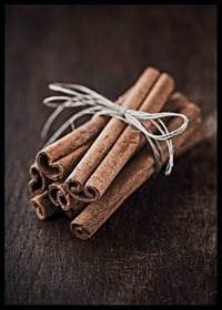 Close-up of cinnamon sticks in a bundle on dark wooden table-6