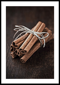 Close-up of cinnamon sticks in a bundle on dark wooden table-0