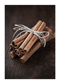 Close-up of cinnamon sticks in a bundle on dark wooden table-1