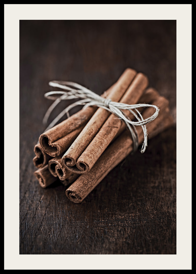 Close-up of cinnamon sticks in a bundle on dark wooden table-12
