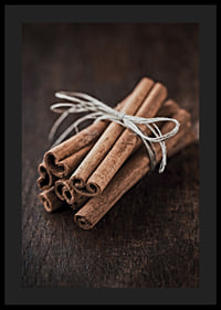 Close-up of cinnamon sticks in a bundle on dark wooden table-4
