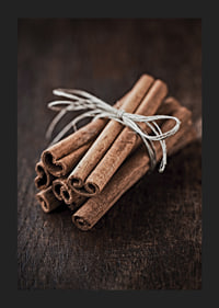 Close-up of cinnamon sticks in a bundle on dark wooden table-5