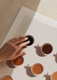 Nine coffee cups from above in different shades of brown on a light background-3