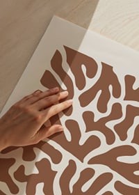 Abstract brown organic shapes against sand colored background-3
