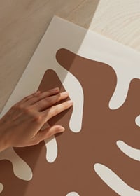 Abstract graphic shape in rust brown on a sand-colored background-3