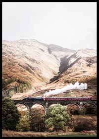 Steam train on stone viaduct in front of bright mountains in autumn landscape-6