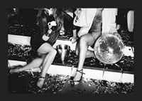 Black and white photograph of two women on party stairs with disco ball-5