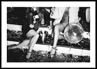 Black and white photograph of two women on party stairs with disco ball-0