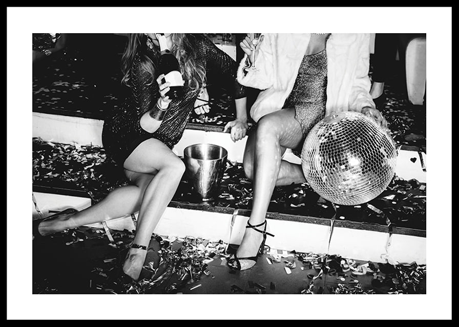 Black and white photograph of two women on party stairs with disco ball-12