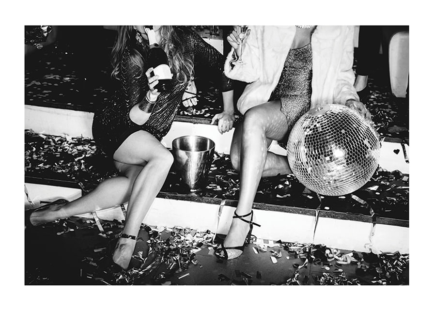 Black and white photograph of two women on party stairs with disco ball-12