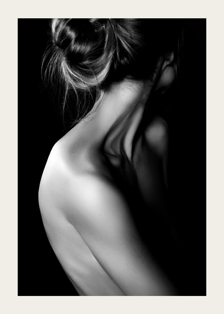 Black and white photograph of woman with updo hair and bare back-12