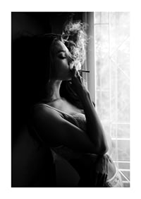 Black and white photograph of woman smoking by a window-1
