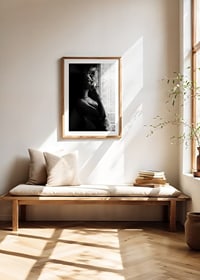 Black and white photograph of woman smoking by a window-8