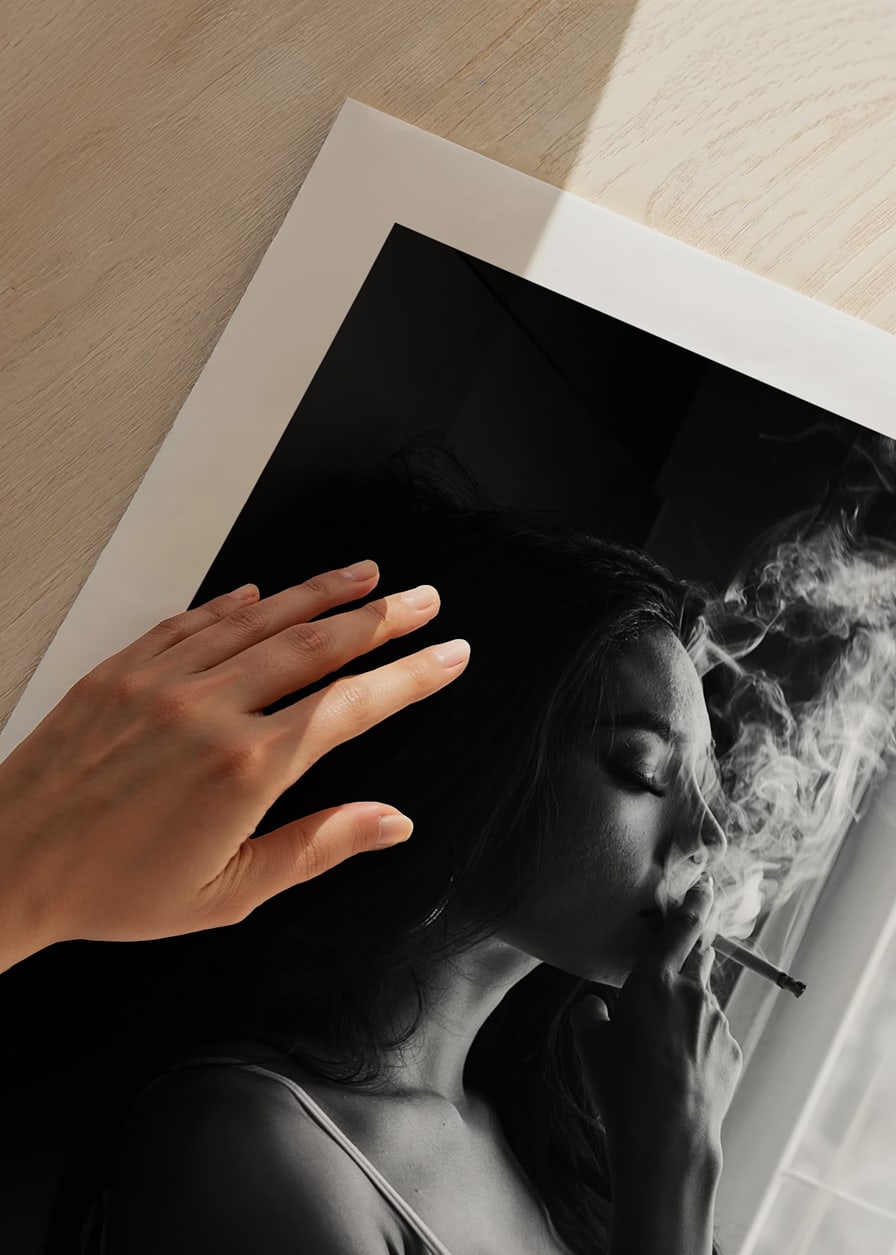 Black and white photograph of woman smoking by a window-12
