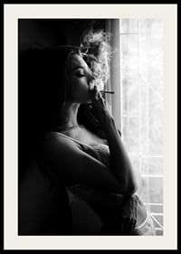 Black and white photograph of woman smoking by a window-2