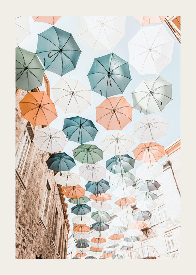 Photograph of colorful umbrellas floating over a city street-12