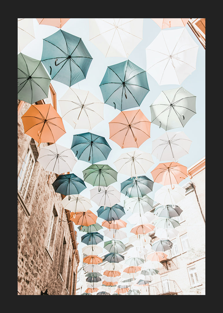 Photograph of colorful umbrellas floating over a city street-12