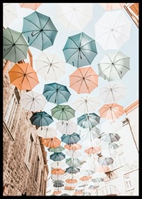 Photograph of colorful umbrellas floating over a city street-6