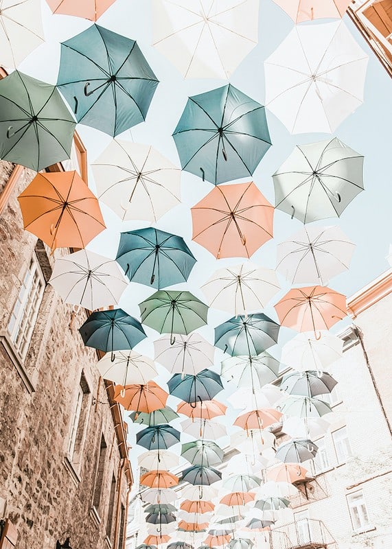 Photograph of colorful umbrellas floating over a city street-12
