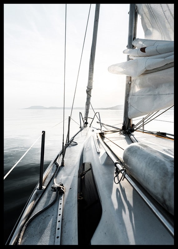 Photograph of sailboat deck with white sails and calm sea-12