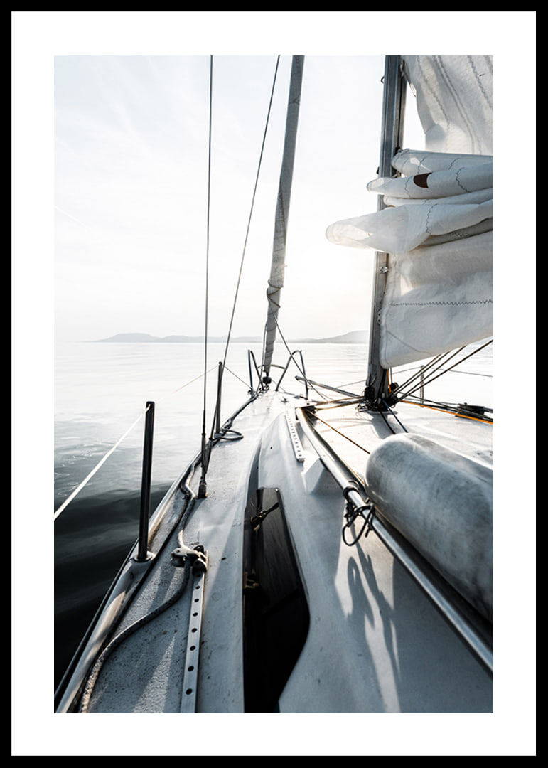 Photograph of sailboat deck with white sails and calm sea-12
