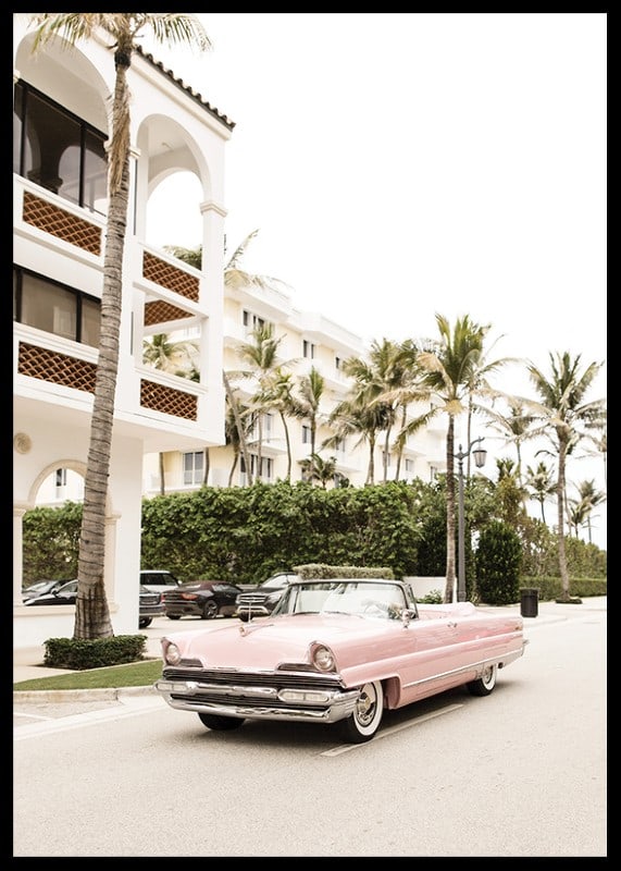 Photographic vintage car in pink in front of palm-lined buildings-12
